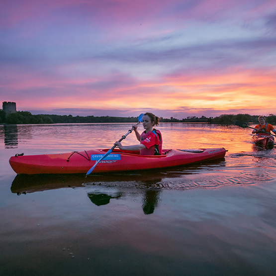 Sunset canoeing on Lough Oughter near Clough Oughter Castle, Co Cavan. Ireland's Hidden Heartland, IHH
